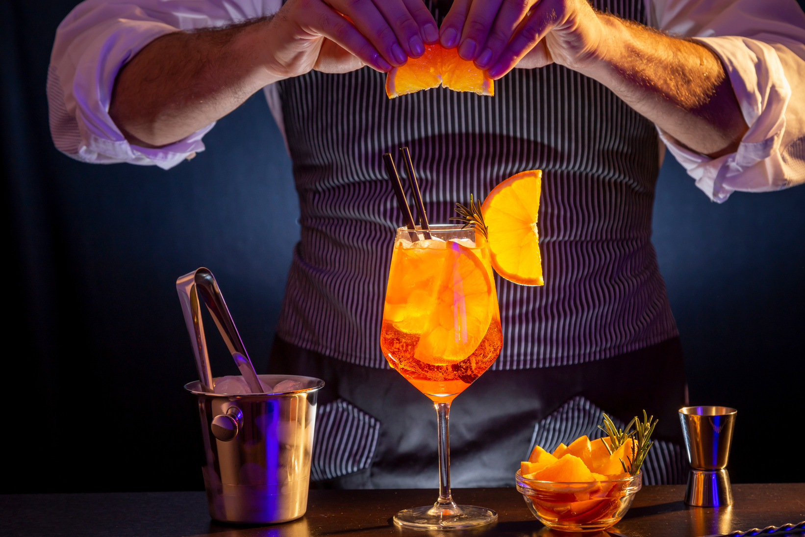 Bartender making Aperol spritz cocktail